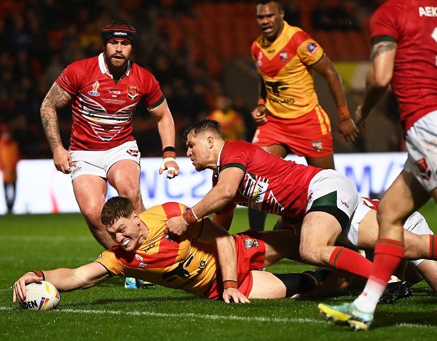 DONCASTER, ENGLAND - OCTOBER 31: Dan Russell of Papua New Guinea goes over to score their sides fourth try during the Rugby League World Cup 2021 Pool D match between Papua New Guinea and Wales at the Keepmoat Stadium on October 31, 2022 in Doncaster, England. (Photo by Gareth Copley/Getty Images)