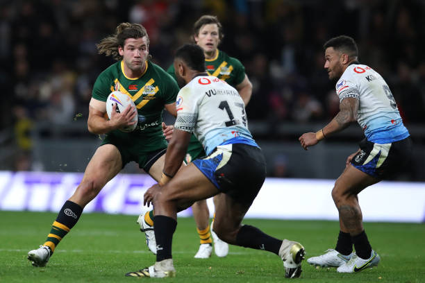 LEEDS, ENGLAND - OCTOBER 15: Patrick Carrigan of Australia runs at King Vuniyayawa of Fiji during the Rugby League World Cup 2021 Pool B match between Australia and Fiji at Headingley on October 15, 2022 in Leeds, England. (Photo by Jan Kruger/Getty Images for RLWC)
