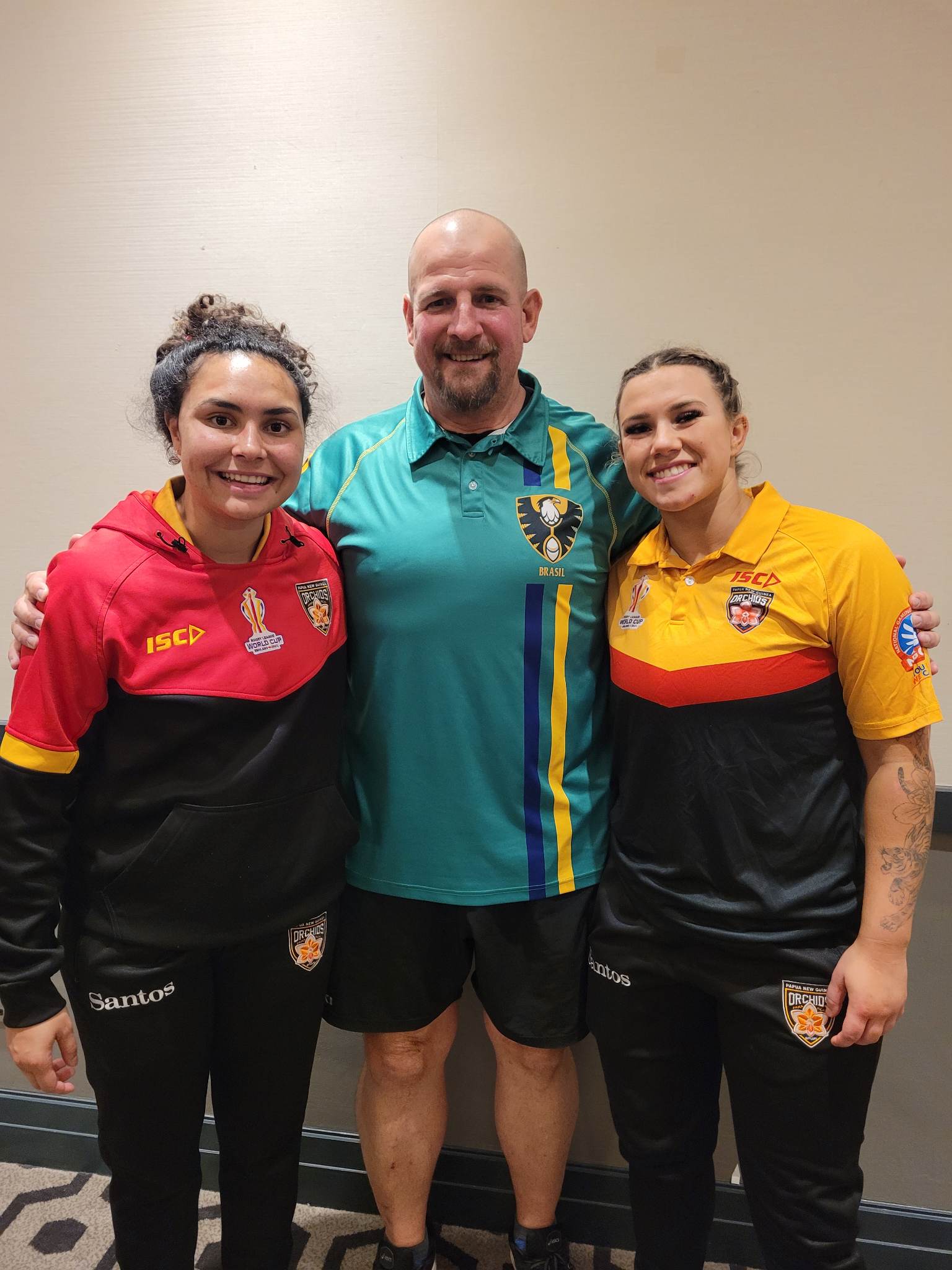 PNG Orchids Shellie Long and Emily Veivers along with current Tigers trainer Lee Munt with Brazil.